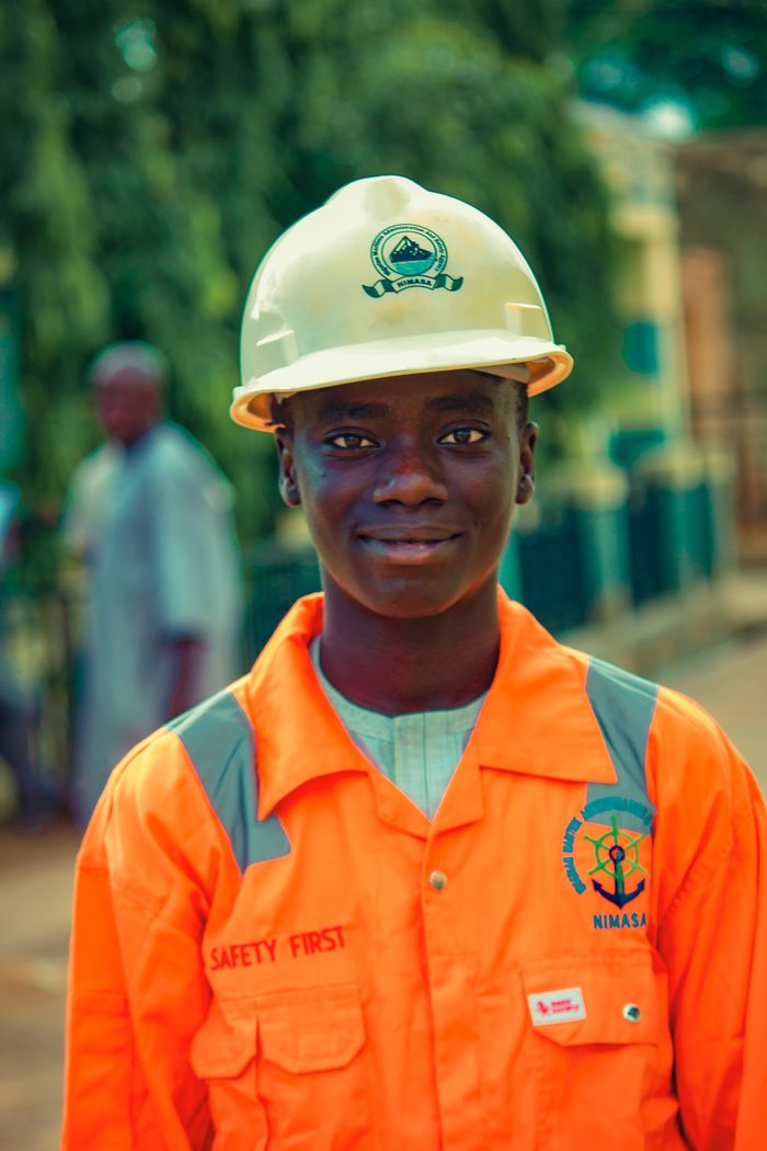 Crafting Captivating Headlines: Your awesome post title goes here A young male worker in safety gear and helmet standing outdoors, emphasizing safety and professionalism.