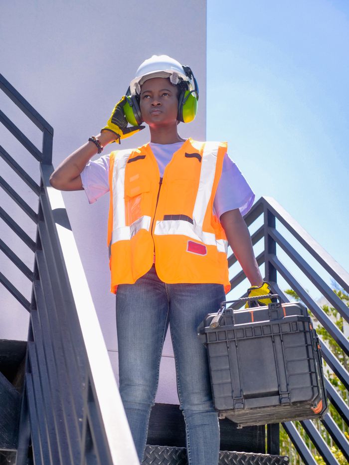 Mastering the First Impression: Your intriguing post title goes here A construction worker wearing PPE stands on a staircase holding a tool box.
